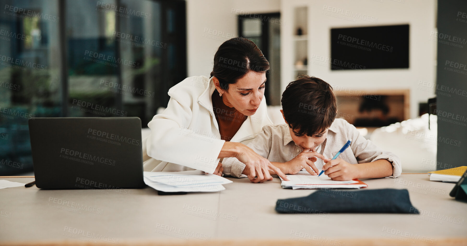 Buy stock photo Education, family and remote work mother with son in home for business or homework task. Laptop, learning and writing with boy child and single parent woman at counter for freelance or study
