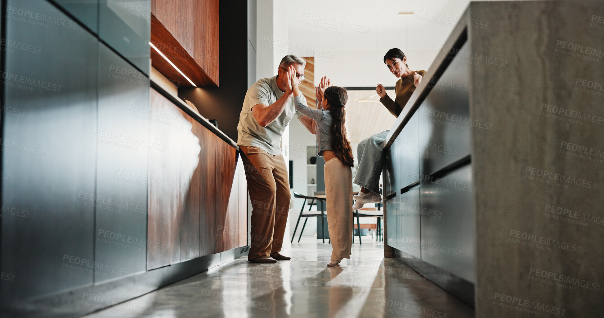 Buy stock photo Parents, kid and high five in kitchen for support, well done and encouragement for child development. Mother, father and celebration with girl in family home for achievement, success and excited