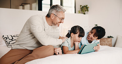 Buy stock photo Tablet, happy and family on bed in home with discussion on movie, film or series choice together. Relax, digital technology and girl child with mother and father for streaming show in bedroom.