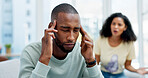 Argument, stress and man on sofa in home with infidelity, cheating or toxic marriage with divorce. Upset, couple and male person in living room for disagreement in relationship with breakup in house.