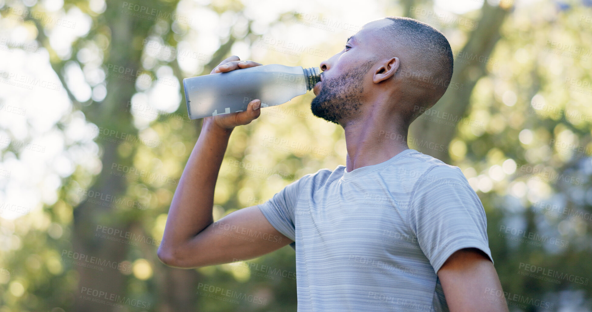 Buy stock photo Fitness, man and drinking water for thirst at park with cardio break, runner recovery and nutrition. Athlete, black person and beverage in nature for exercise electrolytes, hydration or healthy detox