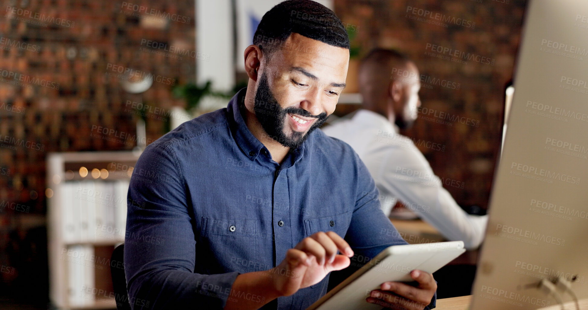 Buy stock photo Reading, smile and man with tablet in office, planning system update and software development at night. Tech, late and app developer with testing for digital feature, programming or project deadline