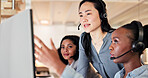 Women, headset and team with computer at call center for advice, insight or point at insurance company. People, advisor or consultant with voip, solution or customer service at risk management agency