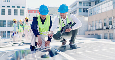 Buy stock photo Engineer, men and tablet outdoor with solar panel inspection, point and talk for renewable energy. Technician, people and photovoltaic system on rooftop with tech, PPE or teamwork for maintenance job