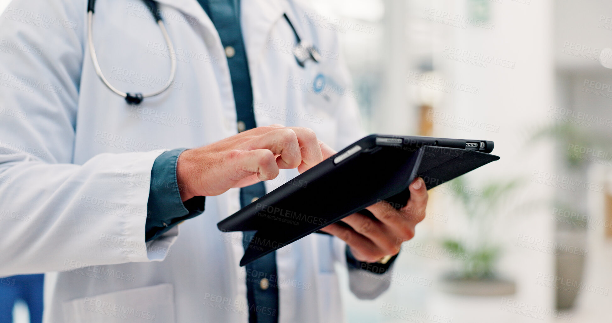 Buy stock photo Doctor, man and hands in hospital with tablet, scroll telehealth app and check schedule for appointment. Healthcare worker, person and typing in clinic with tech, medical research or online calendar.