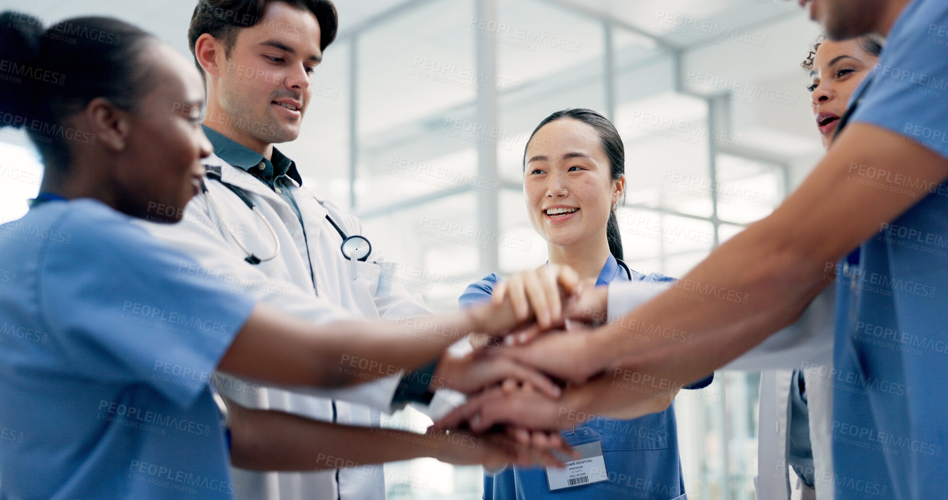 Buy stock photo Medical, team and hands together in hospital with collaboration, connection or group synergy for goals. Happy, healthcare worker and people in clinic with stack, solidarity and cooperation for job.