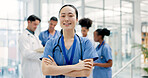 Woman, meeting and portrait of nurse in hospital for medical support, smile and help in uniform. Healthcare, clinic and person with confidence, pride and arms crossed for career, job or surgery plan