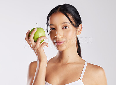 Buy stock photo Woman, apple and diet in studio with portrait, digestion or smile for wellness on white background. Girl, confident and organic fruit for detox, nutrition and gut health for weight loss in Costa Rica