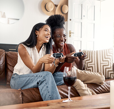 Buy stock photo Gaming, friends or women with controller on sofa, play together or weekend entertainment for bonding. Wine, happy and competitive people with video game in home, online contest and match for fun