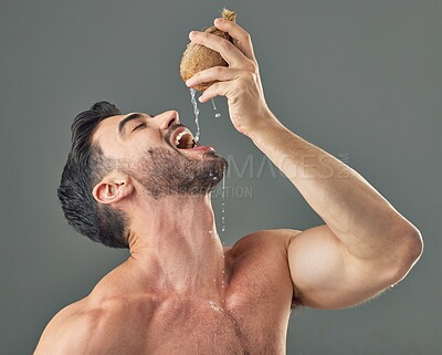 Buy stock photo Man, coconut water and dermatology in studio for natural, hydration and organic product. Fruit, detox and healthy skincare with moisturiser, wellness and sustainable cosmetics on gray background