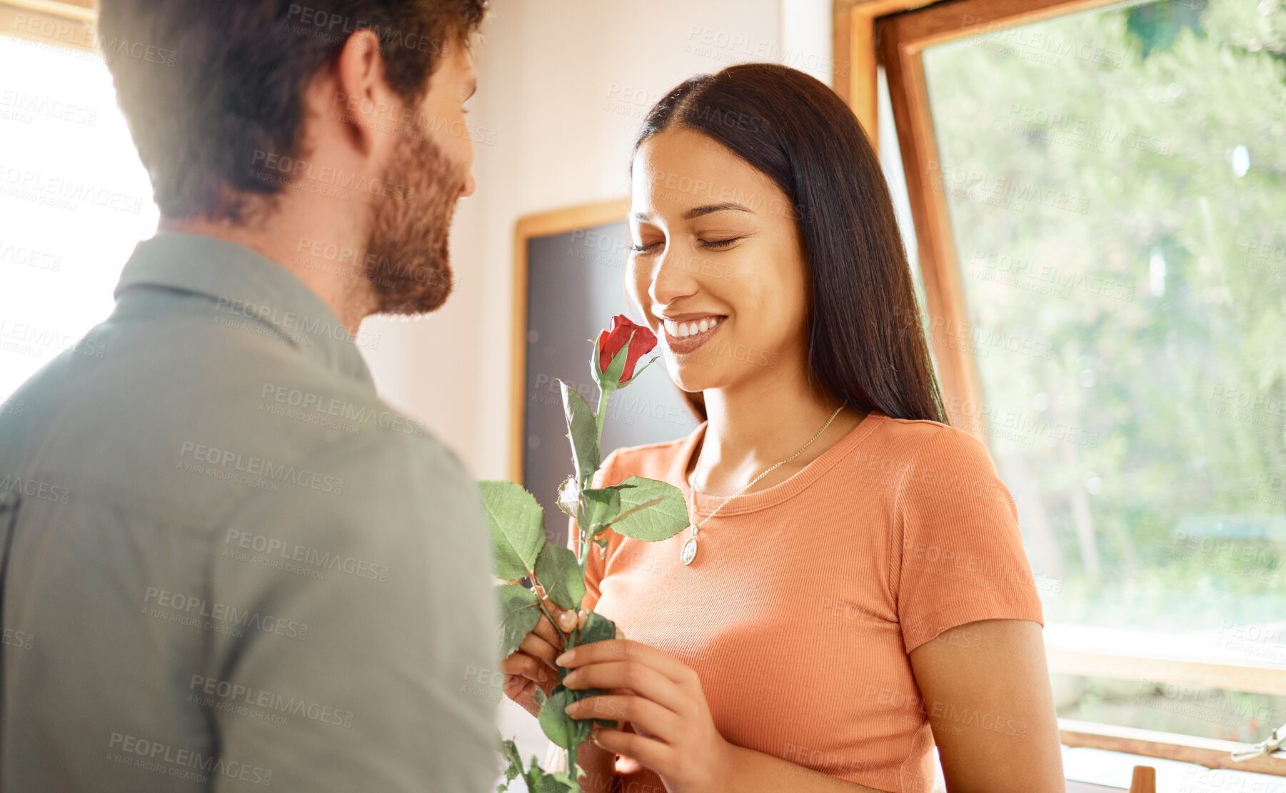 Buy stock photo Happy, couple and love with roses in home for care, partner appreciation and anniversary gift. Smile, people and flowers with affection for loyalty, gratitude and romantic present on special occasion