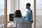 Two business women using computer in office african american team leader woman working with colleague brainstorming ideas