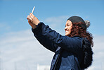 Happy travel woman taking selfie photo using smartphone camera sharing vacation holding mobile phone wearing winter clothes