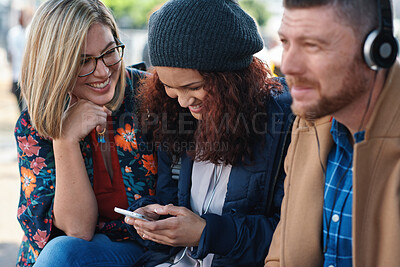 Buy stock photo Women, friends and laugh with phone at park for funny video, meme or post on web with reunion. People, relax and share joke with mobile app, happy and chat with gossip on social media in urban town