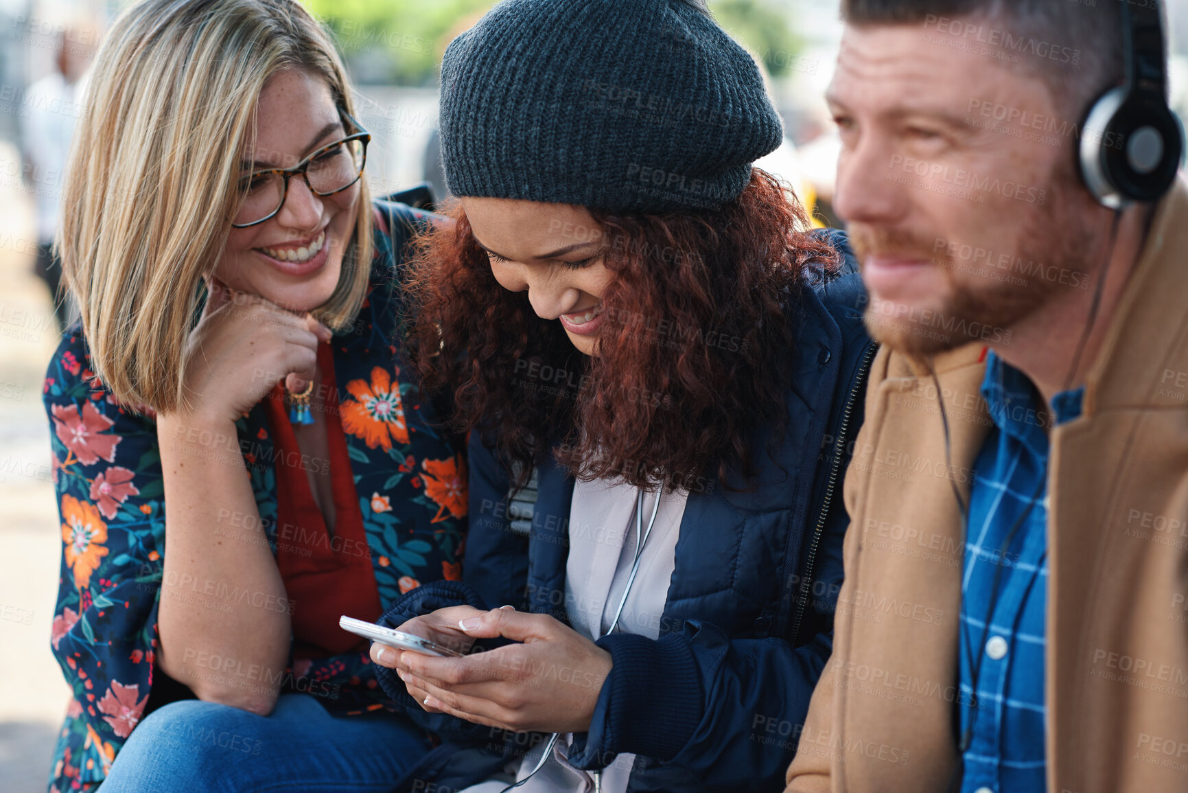 Buy stock photo Women, friends and laugh with phone at park for funny video, meme or post on web with reunion. People, relax and share joke with mobile app, happy and chat with gossip on social media in urban town