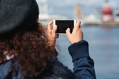 Buy stock photo Travel, photo or woman in town with phone screen, online memories or post update on weekend break. Digital, back and person at harbor with tech, social media picture or memory capture on outdoor trip