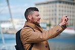 Man using smartphone taking photo of harbour with mobile phone camera tourist on vacation