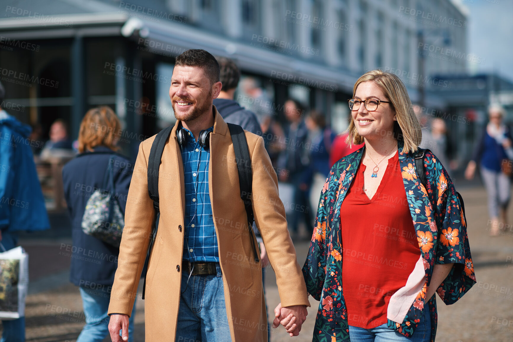 Buy stock photo Travel, holding hands and couple in city for walking to explore on holiday, vacation and trip. Marriage, happy and man with woman for bonding, relationship and tourism for adventure together in town