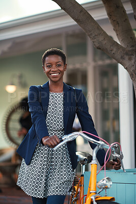Buy stock photo Black woman, happy and portrait in bicycle in city for travel, pride and eco friendly commute on sidewalk. African person, bike and smile with confidence, outdoor or sustainable transport in town