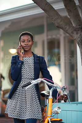 Buy stock photo Black woman, phone call and chat with bicycle in city for travel, break and contact on sidewalk. African person, bike and smile with communication, mobile network or sustainable transport in town