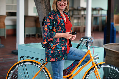 Buy stock photo Happy woman, bicycle and phone in city for travel with glasses, portrait and eco friendly commute. Person, smile and vintage bike with confidence in town, outdoor and sustainable transport in Spain