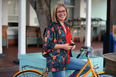 Buy stock photo Happy woman, bike and phone in city for travel with glasses, portrait and eco friendly commute. Person, smile and vintage bicycle with confidence in town, outdoor and sustainable transport in Spain