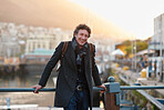Portrait happy mature man smiling enjoying urban lifestyle in city with waterfront harbour in background