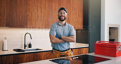 Buy stock photo Portrait, plumber and smile in kitchen with arms crossed, repair skills and pride for maintenance job. Confident, person or handyman in home with diy toolbox, goggles or about us for plumbing company