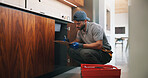 Plumber, man and writing in kitchen with clipboard, inspection and technician for quality assurance. Handyman, person and notes in house with plumbing checklist, review pipeline and home maintenance.