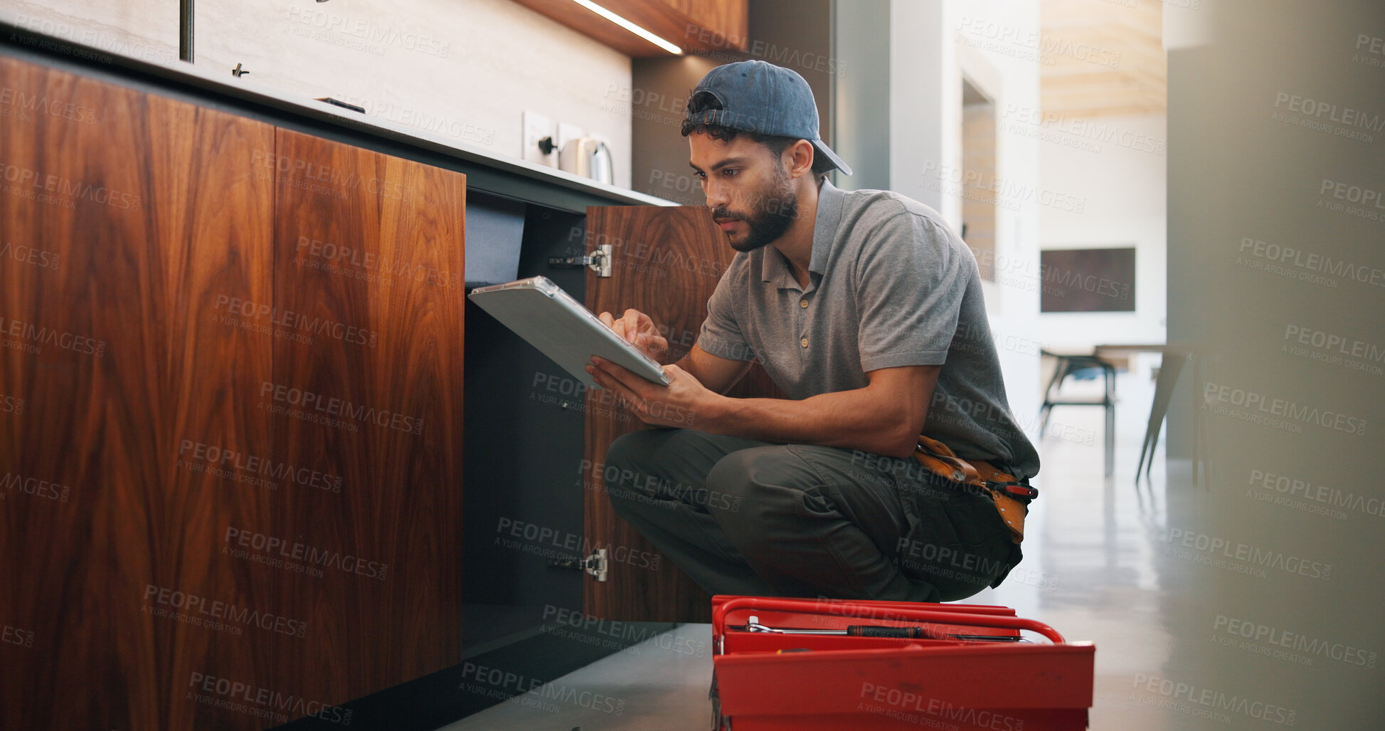 Buy stock photo Plumber, man and inspection in kitchen with tablet, email invoice or technician for quality assurance. Handyman, person and scroll in house with tech, plumbing checklist or quote for home maintenance