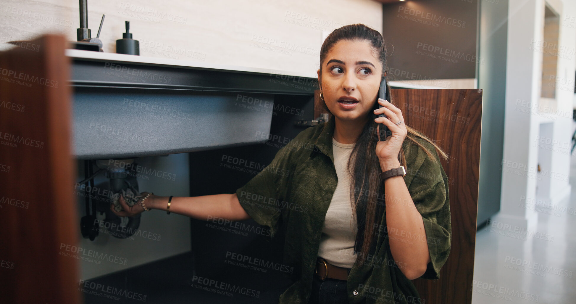 Buy stock photo Phone call, pipes and thinking with woman in kitchen of home for plumbing or repair service. Communication, leak and sink with person in apartment for contractor, fixing or maintenance question