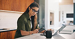 Laptop, phone and remote work with woman n kitchen of home for online planning or research. App, coffee and computer with freelance person at counter in apartment for small business communication