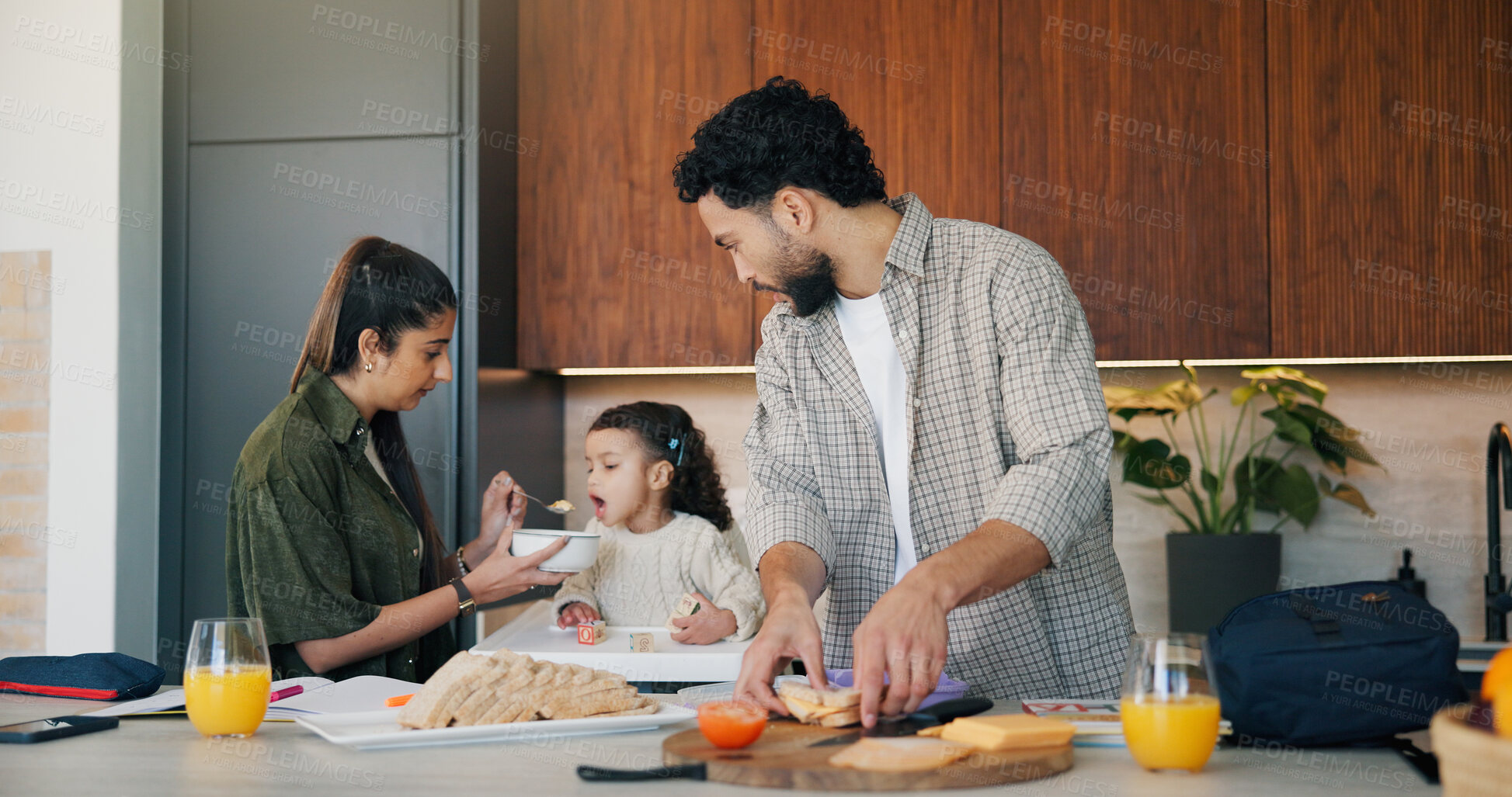 Buy stock photo Family, breakfast and feeding with toddler in kitchen for morning or back to school preparation. Dad, mom and child eating with food, sandwich or meal prep for early childhood development in home