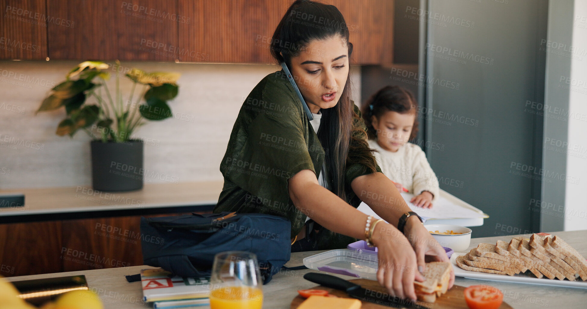 Buy stock photo Daughter, lunch and phone call with mother packing in kitchen for multitasking or preparation. Busy, getting ready and food with single parent making school snack for girl child in apartment