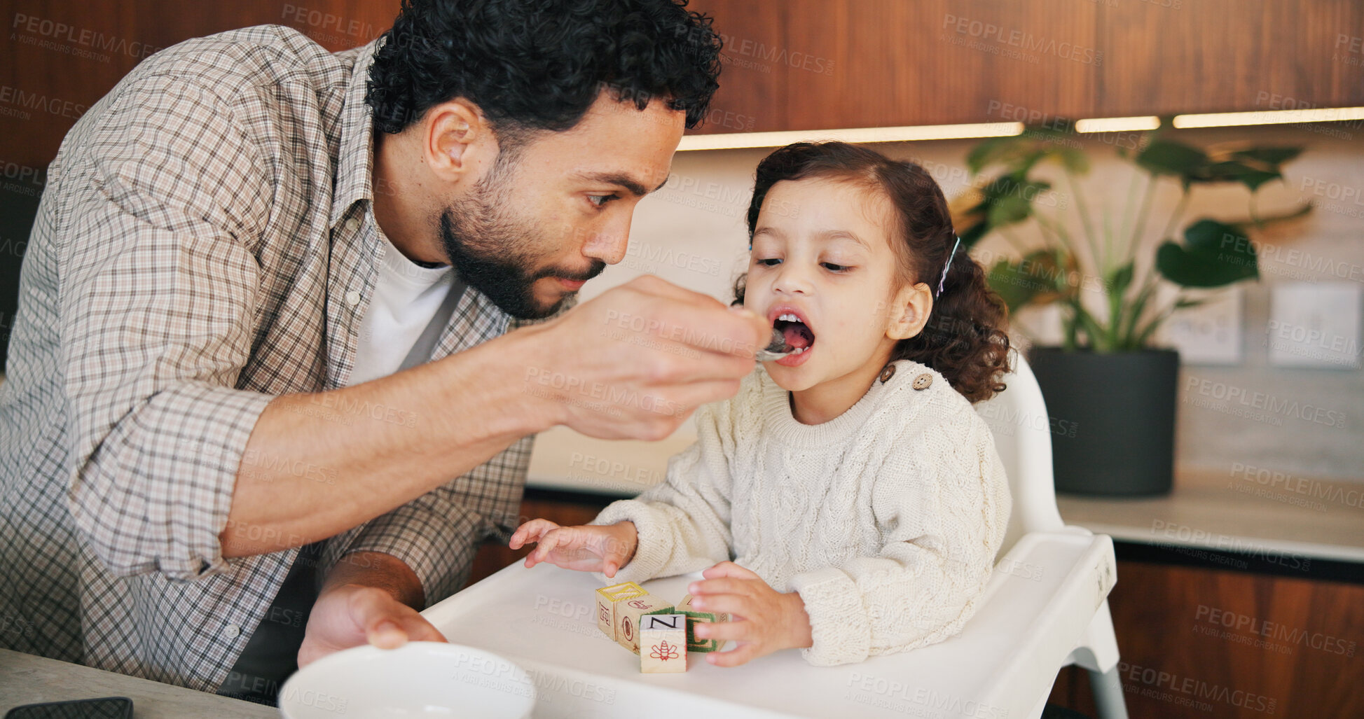 Buy stock photo Father, child and feeding food in house for nutrition, happy and support wellness of daughter. Man, toddler girl and playing toy blocks with breakfast, healthy diet and development or growth and care