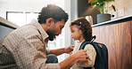 Education, dad and child with backpack in kitchen, family and getting ready for first day of school. Man, home and help girl with bag for daycare, morning routine and preparing toddler to leave