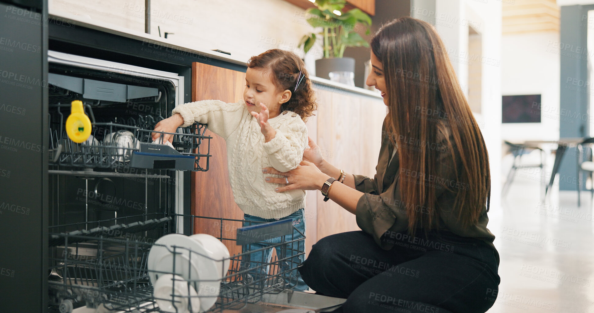 Buy stock photo Child, helping and mother with dishes in kitchen for hygiene, teaching cleanliness and guidance. Smile, woman or toddler with dishwasher for sanitation, household chores and supervision for tidy home