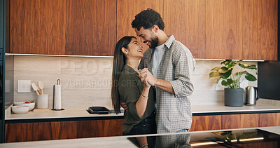 Buy stock photo Couple, holding hands and dancing with smile in kitchen, commitment and bonding with partner or love. Happy people, together and celebration for anniversary, romance and rhythm with spouse in home