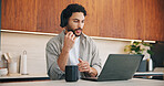 Headset, laptop and remote work with man in kitchen of home for customer service or support. Coffee, computer and virtual assistance with freelance agent at counter in apartment for communication
