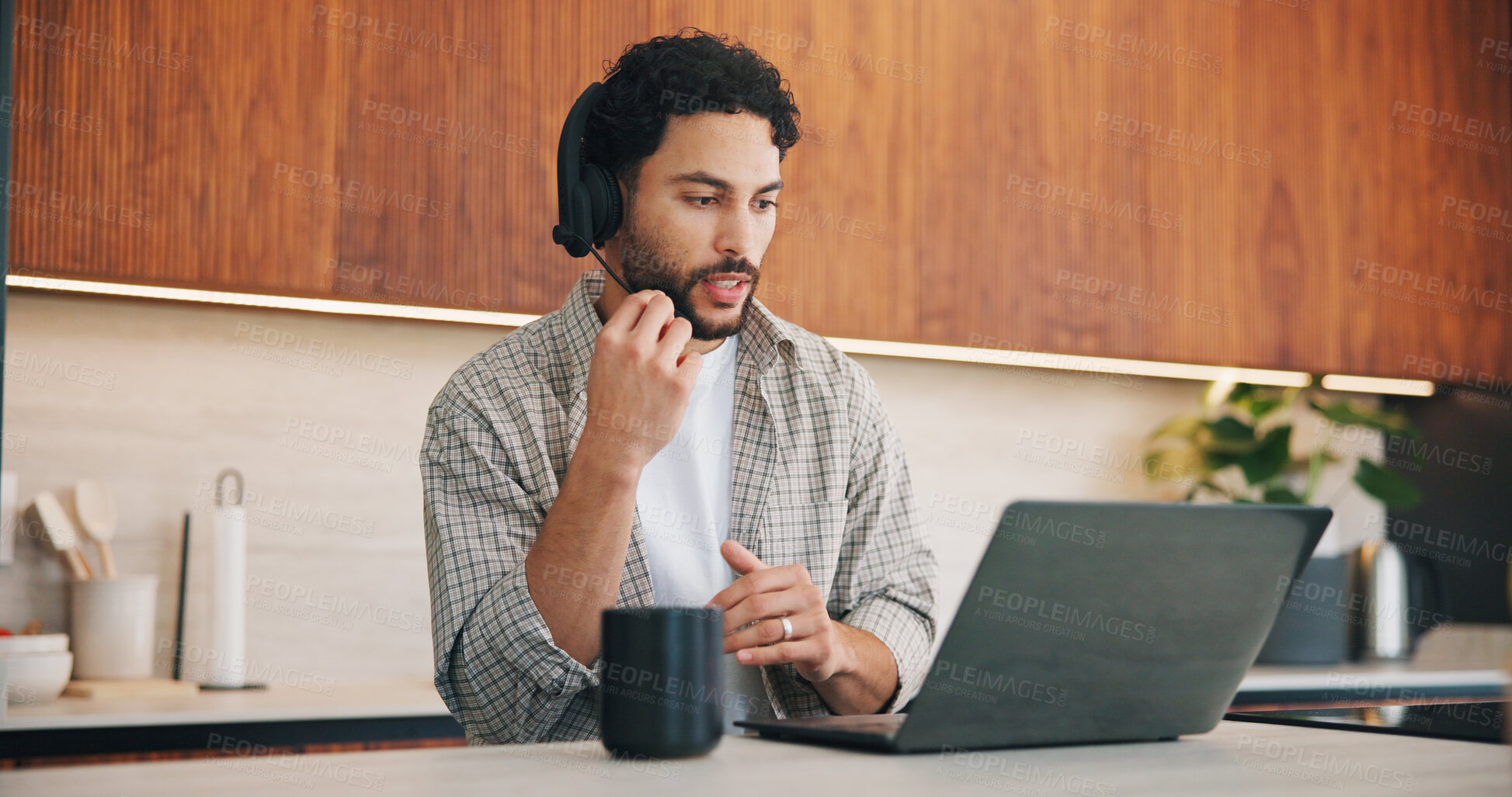 Buy stock photo Headset, laptop and remote work with man in kitchen of home for customer service or support. Coffee, computer and virtual assistance with freelance agent at counter in apartment for communication