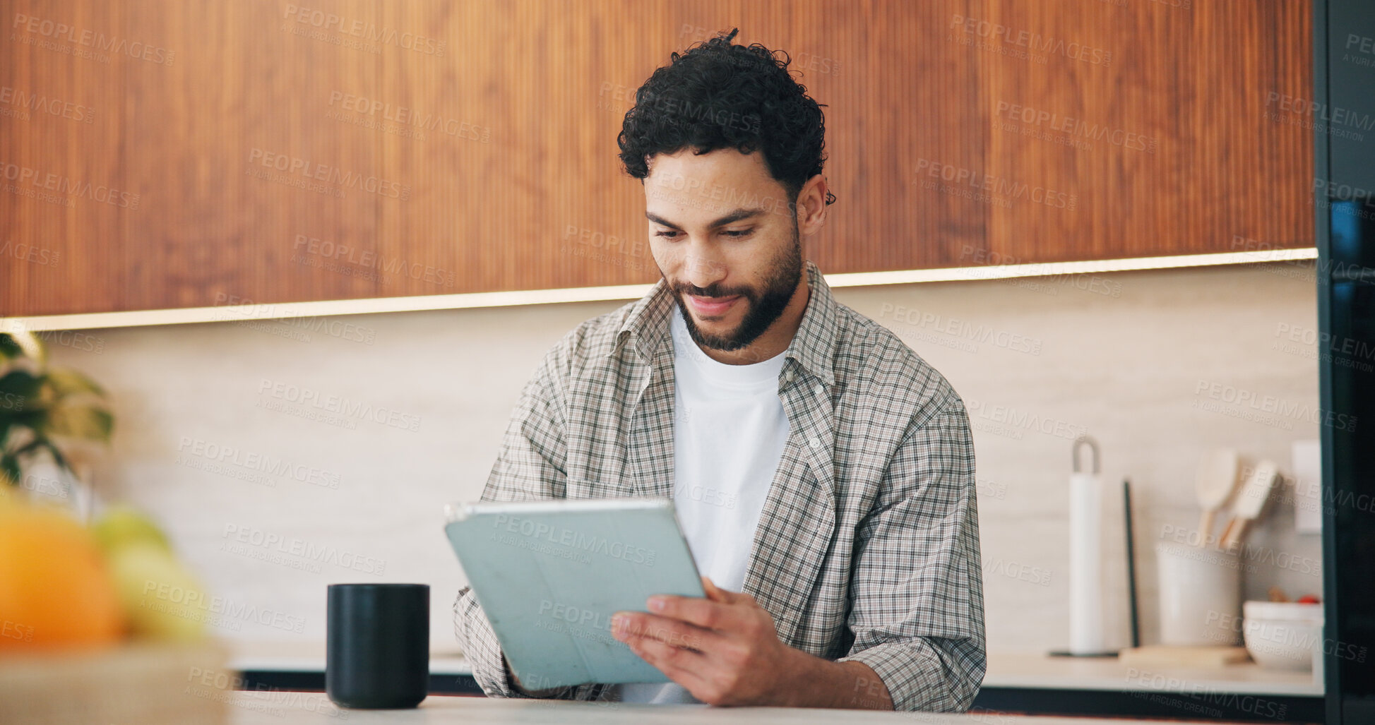 Buy stock photo Remote work, smile or man in house with tablet, publisher communication or novel editing in kitchen. WFH, review or author with tech, manuscript planning or editor feedback in story development.