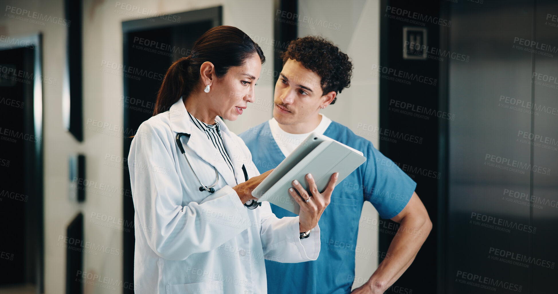 Buy stock photo Doctor, nurse and discussion with tablet in hospital for health advice, assistance or help. Man, woman or healthcare workers with technology for medical results, feedback or planning procedure