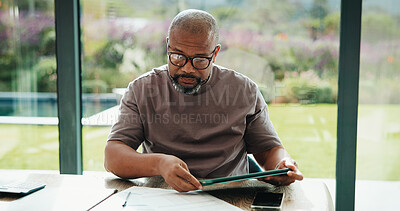 Buy stock photo Man, reading and documents in home with tablet, financial planning or online website for utility bills. Mature, black person and glasses in house with tech, paperwork or budget for household expenses