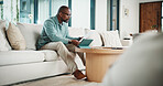 Paperwork, tablet and black man in home for finance review, budget planning and payment for bills. House, documents and mature person on digital tech for online banking, expenses and financial report