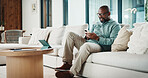 Black man, phone and texting with remote work from home with smile, broker or check notification. Mature person, financial advisor and virtual consultant with mobile app, typing or feedback in house
