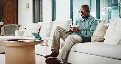 Buy stock photo Black man, phone and texting with remote work from home with smile, broker or check notification. Mature person, financial advisor and virtual consultant with mobile app, typing or feedback in house