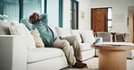 Black man, happy and documents for taxes in home with relief, finished or stretching on sofa in lounge. Mature person, smile and relax with financial compliance, bills or budget review in living room