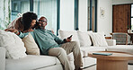 Happy, couple and watching tv on couch, home and bonding with partner on weekend or streaming movie. Mature people, love and connection with spouse on break, smile and relax together in living room