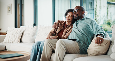 Buy stock photo Couple, laugh and watching tv on couch, lounge and bonding with partner or happy on weekend in home. Mature African people, hug and connection with spouse, smile and streaming funny comedy movies