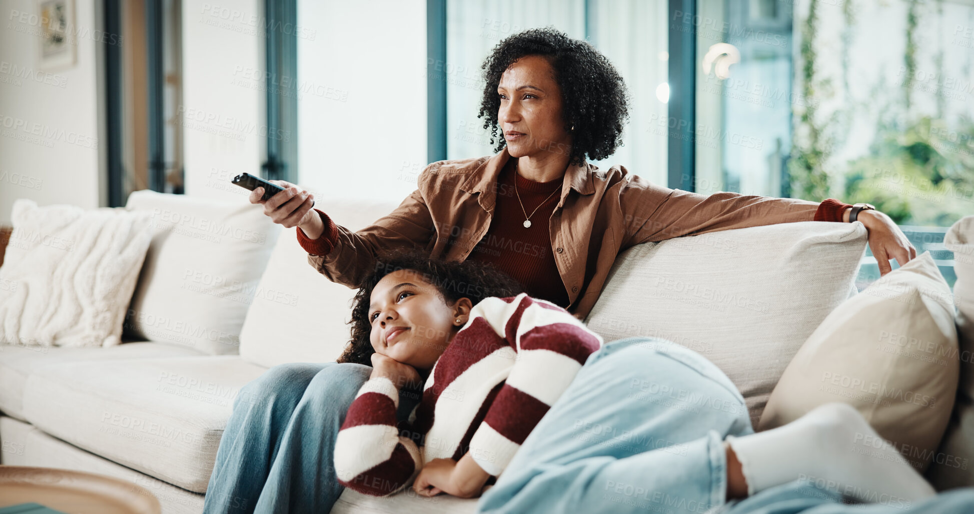 Buy stock photo Mom, child and relax with watching tv on sofa, remote and bonding with movie choice in living room. People, mother and daughter with streaming services, film or subscription on couch at family house